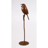 A JAPANESE BRONZE MODEL BIRD ON STAND - the underside with a seal mark 16cm
