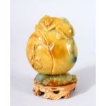 A GOOD CHINESE CARVED JADE MONKEY, PEACH & LOTUS SNUFF BOTTLE AND STAND - the upper part carved with