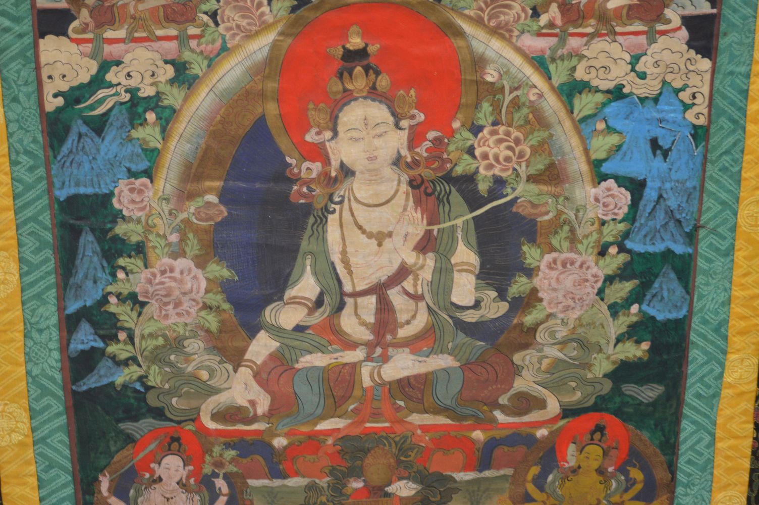 A GOOD LARGE 20TH CENTURY TIBETAN THANKA, mounted and framed, 120cm x 100cm. - Image 4 of 6