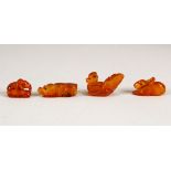 FOUR CHINESE CARVED AMBER MINIATURE ANIMALS, largest 3cm long (4).