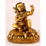 A CHINESE GILT BRONZE FIGURE OF A DEITY, in two parts, seated holding a bowl, 15cm high.