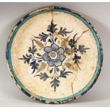 A RARE 16TH CENTURY INDIAN MULTAN POTTERY DISH, the centre painted with a floral spray within a