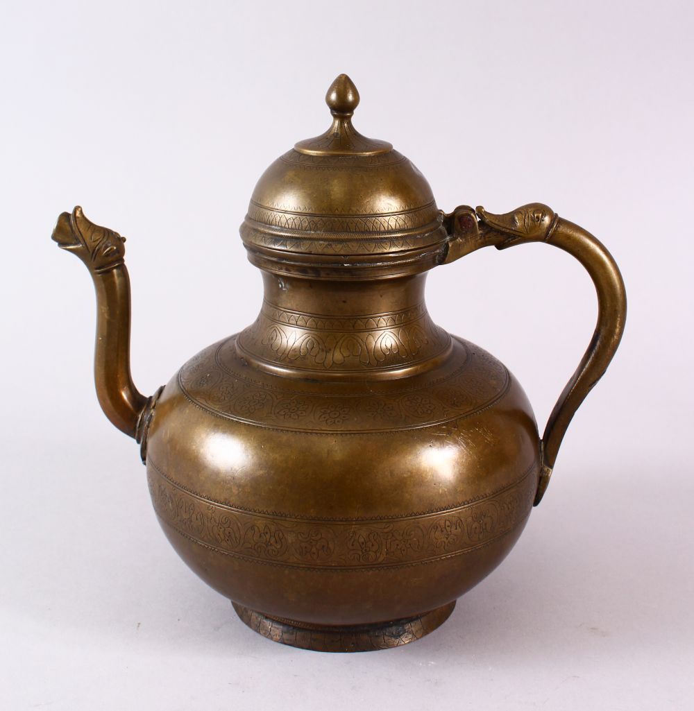 AN 18TH CENTURY MUGHAL INDIAN BRASS EWER, with animal formed handle and spout, 22cm high.