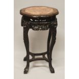 A 19TH CENTURY CHINESE CARVED HARDWOOD & MARBLE INSET STAND - the stand carved with fruit and