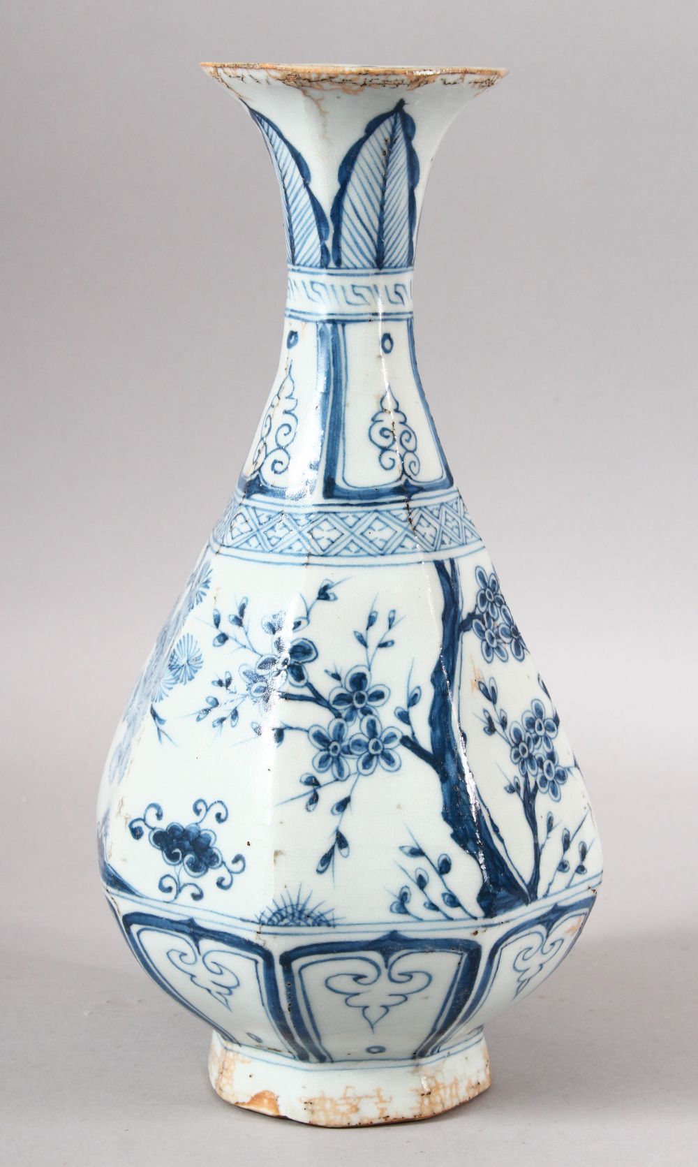 A CHINESE MING STYLE BLUE & WHITE PORCELAIN OCTAGONAL VASE - decorated with various native trees,