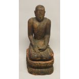 A LARGE AND HEAVY CARVED WOOD FIGURE OF BUDDHA, 79cm high.