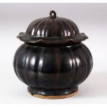 A CHINSES RIBBED BODY BROWN GLAZED JAR & COVER - the jar with a ribbed body, the cover with a