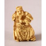 A JAPANESE MEIJI PERIOD CARVED IVORY NETSUKE OF A WARRIOR - the warrior stood in traditional