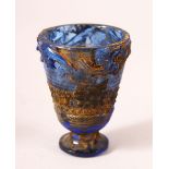 A CHINESE ARCHAIC STYLE BLUE GLASS CUP, decorated with chilong, 7cm high.