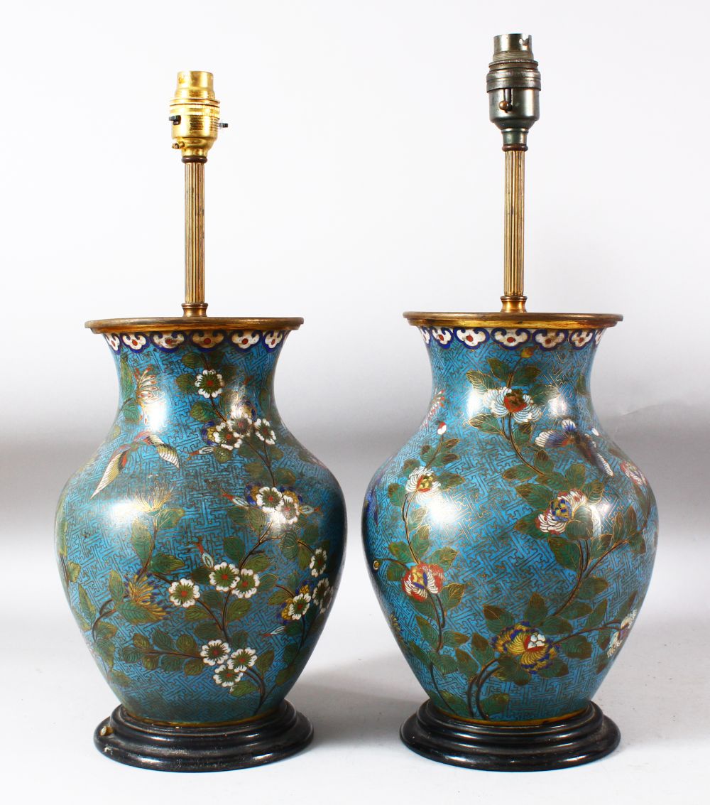 A PAIR OF CHINESE BLUE GROUND CLOISONNE VASES / LAMPS, decorated with native flora, butterflies