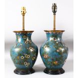 A PAIR OF CHINESE BLUE GROUND CLOISONNE VASES / LAMPS, decorated with native flora, butterflies