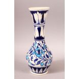 AN ISLAMIC PORCELAIN VASE, blue painted floral decoration in the iznik style, 26.5cm high.