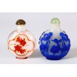TWO CHINESE OVERLAY GLASS SNUFF BOTTLES - one of frosted glass with a blue overlay depicting