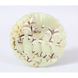 A CHINESE CARVED JADE DISK // PENDANT - Carved with birds aside foliage. 6.5cm