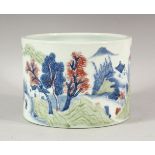 A CHINESE BLUE, WHITE AND COPPER RED BRUSH POT, the sides with a continuous scene of houses,