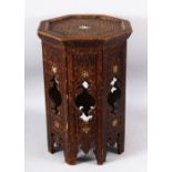 A MOORISH OCTAGONAL OCCASIONAL TABLE with carved decoration, 49cm high, 33cm wide.
