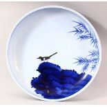 A LARGE JAPANESE MEIJI BLUE & WHITE PORCELAIN DISH - the dish depicting the scenes of a bird