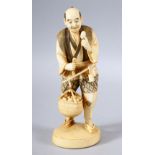 A JAPANESE MEIJI PERIOD CARVED IVORY OKIMONO - - the man stood holding his basket full of produce,