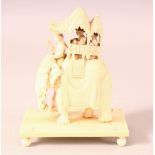 AN EARLY 20TH CENTURY CARVED IVORY GROUP, of an elephant with mahoot, a houda on its back containing