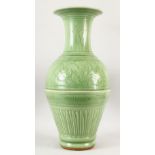 A VERY GOOD LARGE CHINESE CELADON VASE, with panels of flowers and fluted base, 64cm high.