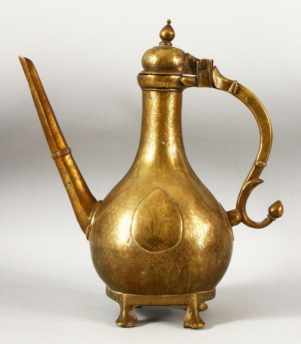 A LARGE 18TH CENTURY MUGHAL INDIAN BRASS EWER, with engraved / chased decoration, 32cm high.