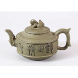 A CHINESE YIXING CLAY TEAPOT & COVER - decorated with calligraphy either side with a lion dog finial