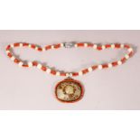 A CHINESE JADE AND CORAL PENDANT AND CHAIN, the pendant with pierced and carved decoration with