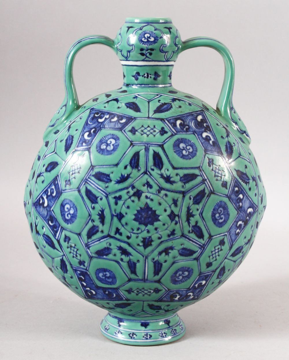 A CHINESE TURQUOISE GROUND TWIN HANDLE PORCELAIN MOON FLASK - the body decorated with geometric