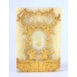 A CHINESE CARVED GILT JADE TABLET - decorated with twin dragon and phoenix, 12cm x 8cm