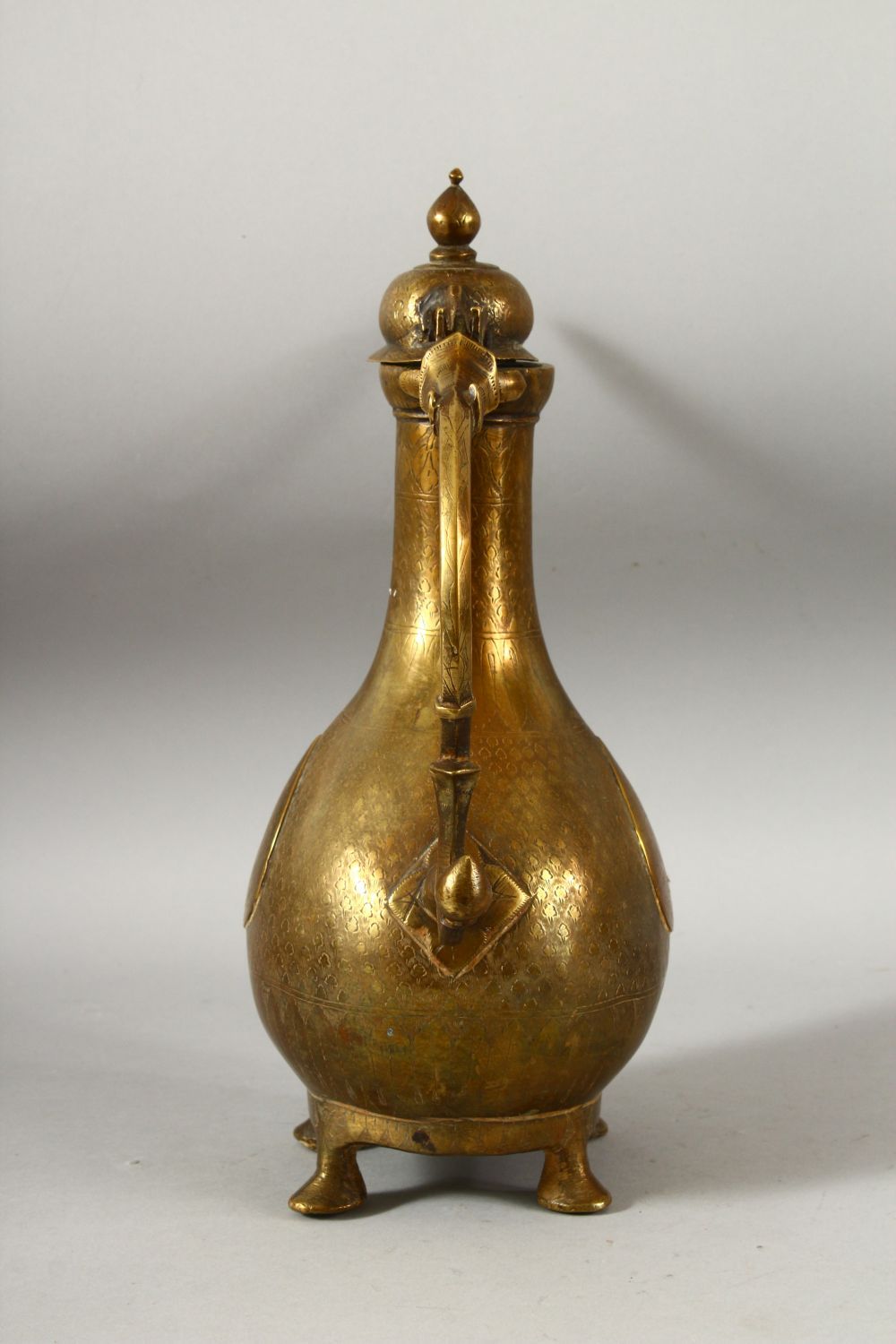 A LARGE 18TH CENTURY MUGHAL INDIAN BRASS EWER, with engraved / chased decoration, 32cm high. - Image 4 of 7