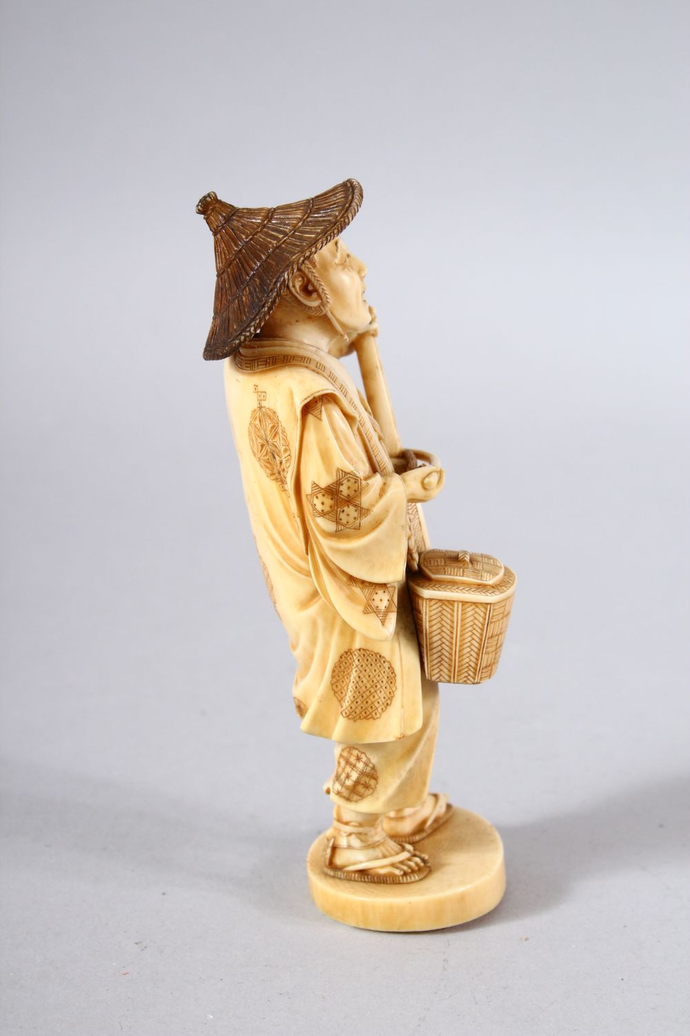 A JAPANESE MEIJI PEPRIOD CARVED IVORY OKIMONO - MUSICIAN - the figure stood holding his basket and - Image 2 of 8