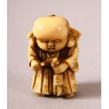 A JAPANESE MEIJI PERIOD CARVED IVORY NETSUKE OF A BOY - the boy stood holding and looking down at