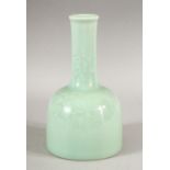 A CHINESE CELADON GLAZED PORCELAIN BOTTLE VASE, the base with six character mark, 19cm high.