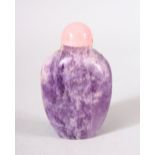 A CHINESE CARVED AMETHYST SNUFF BOTTLE - with a pink stone stopper, 7cm