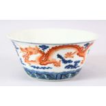 A CHINESE BLUE AND IRON RED PORCELAIN DRAGON BOWL, painted with two dragons chasing the flaming