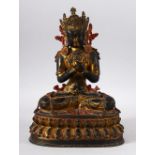 A TIBETAN GILT COPPER FIGURE OF YOGIMI / BUDDHA - in a seated pose with its hand crossed - poly