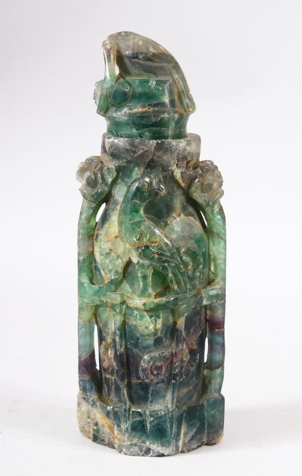 A CHINESE CARVED GREEN HARD STONE LIDDED VESSEL - carved with scenes of birds, 22.5cm