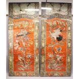 AN IMPRESSIVE PAIR OF CHINESE EMBROIDERED SILK PANELS, each central coral red ground panel