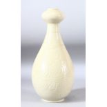 A CHINESE DING STYLE VASE, with carved sgraffito floral sprays to the body, 33cm high.
