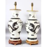 PAIR OF CHINESE CRACKLE GLAZE PORCELAIN LAMP VASES, on fitted wooden stands, the body of each with