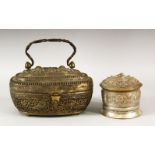 A BURMESE WHITE METAL CIRCULAR BOX AND COVER, with embossed and chased decoration, 9cm diameter,