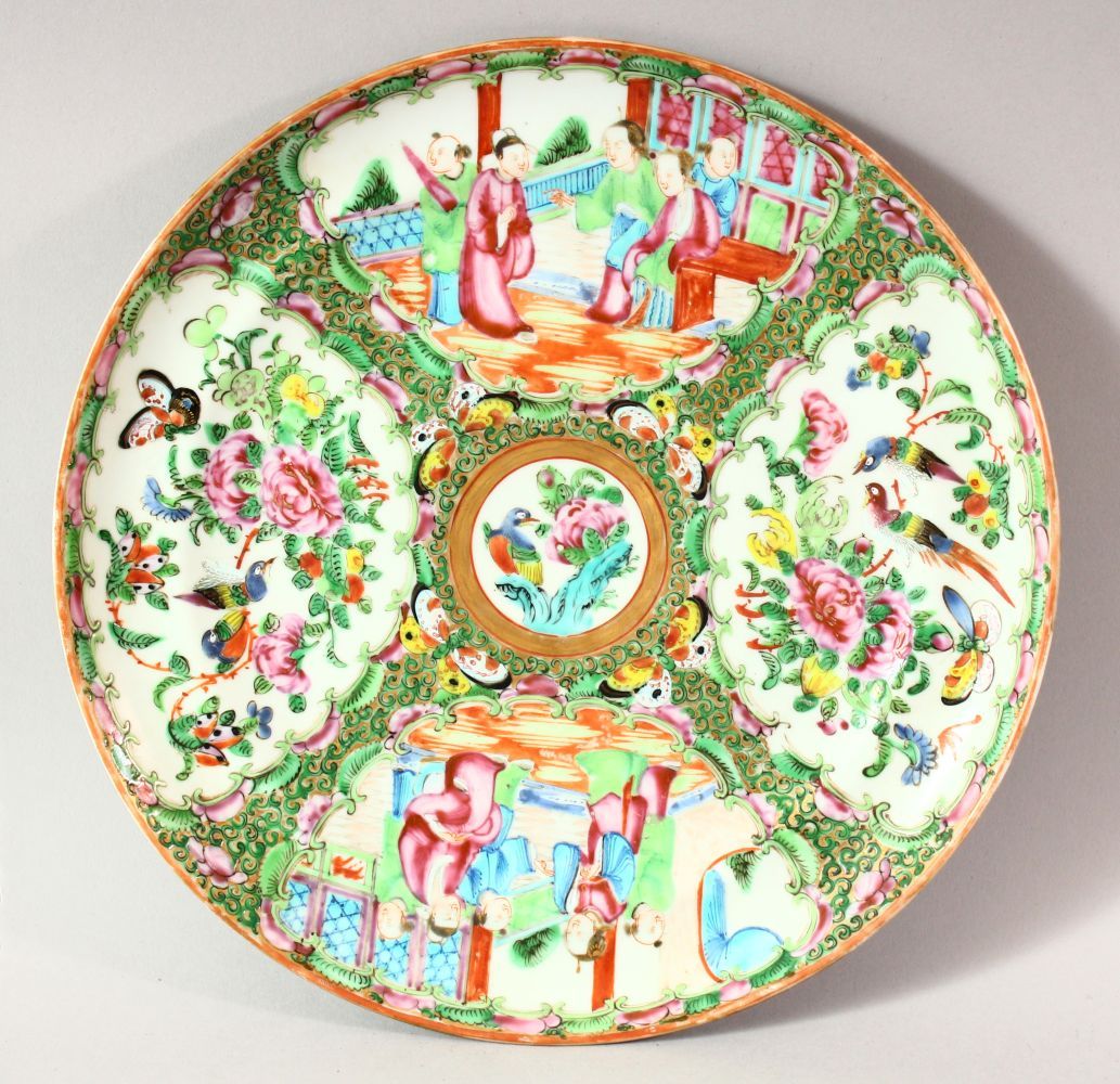 A CHINESE CANTON PORCELAIN PLATE, decorated with panels of figures, birds, butterflies and