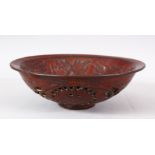 A CHINESE PIERCED POTTERY BOWL - the interior decorated with scenes of flora, the underside with