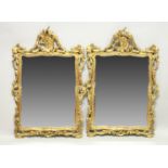 A GOOD PAIR OF DECORATIVE GILT FRAMED PIER MIRRORS, 19th Century or earlier, with pierced and carved