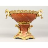 A GOOD PAIR OF RED MARBLE URNS, TWO HANDLE CENTREPIECE with ormolu cherub supports. 12ins high.