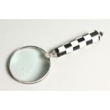 A MAGNIFYING GLASS with a chequered handle.