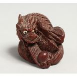 A SMALL JAPANESE WOOD DRAGON NETSUKE signed