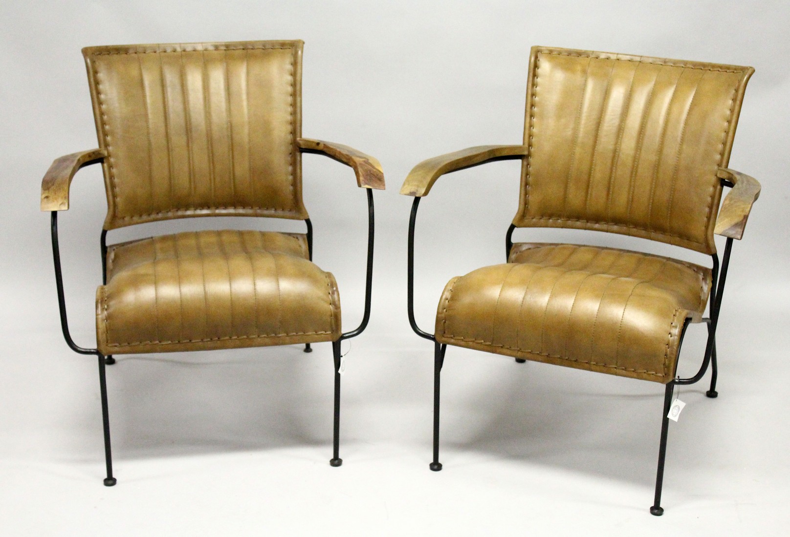 A PAIR OF MODERN LEATHER, WROUGHT IRON AND WALNUT ARMCHAIRS