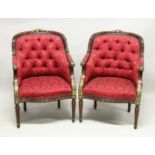 A PAIR OF MAHOGANY AND BUTTON UPHOLSTERED ARMCHAIRS, with parcel gilded carved show wood frames,