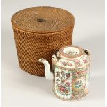 A CANTON TEA POT in a basket